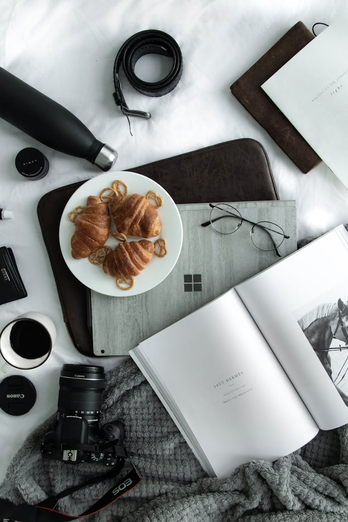Elegant flat lay featuring coffee, croissants, and tech accessories. Perfect for lifestyle visuals.